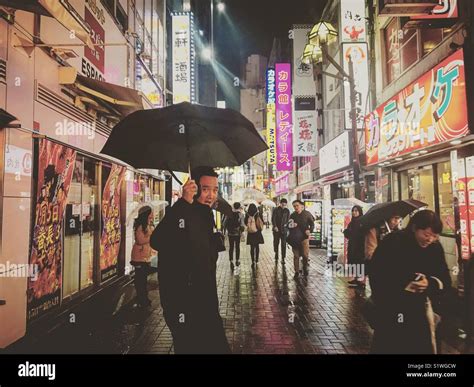 Tokyo night street scene in the rain Stock Photo - Alamy