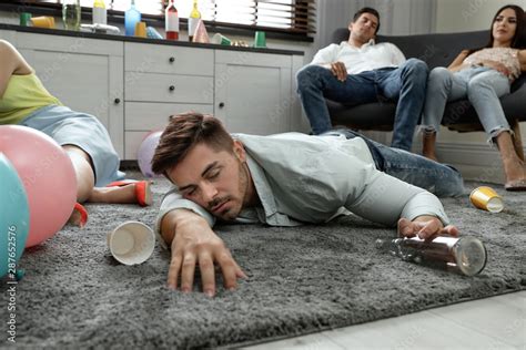 Drunk man sleeping on floor in messy room after party Stock Photo ...