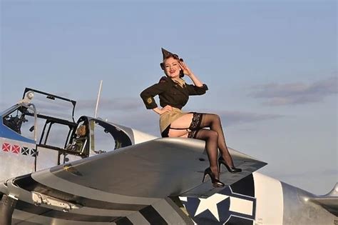 Pin-up girl sitting on the wing of a P-51 Mustang fighter