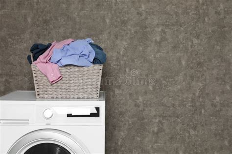 Wicker Laundry Basket Full of Dirty Clothes on Washing Machine Near Color Wall Stock Image ...