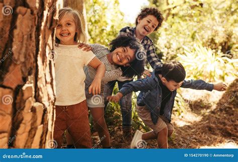 Group of Children Playing Hide and Seek Stock Photo - Image of elementary, forest: 154270190