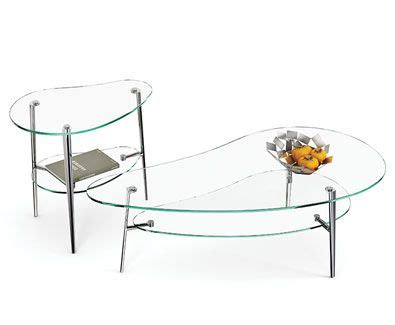 two glass tables with metal legs and a flower vase on one end, both sitting side by side