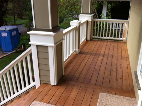 Stained cedar decking with wood railing. Idea for the front porch ...