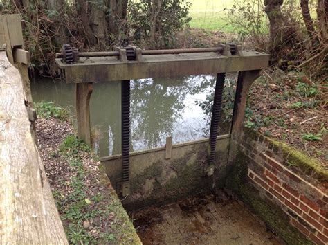 Sluice Gate dated 1921 on Leat at Rudyard Kipling's Mill TN19 7DS East Sussex. UK. The water ...