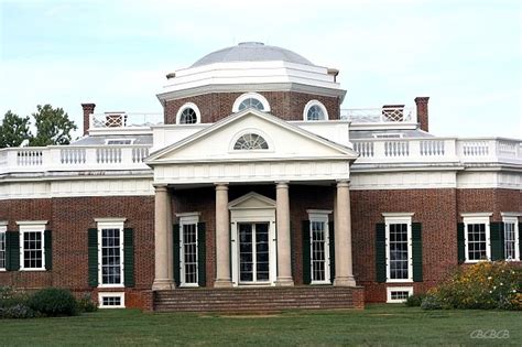 an old brick building with columns and windows on the front lawn ...