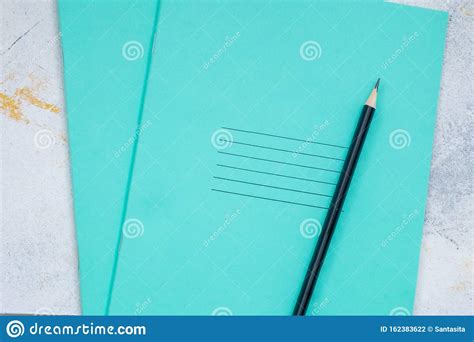 White Desktop, Green Notebook Lies on the Table, Pensil, with Copy Space, for Advertisement ...