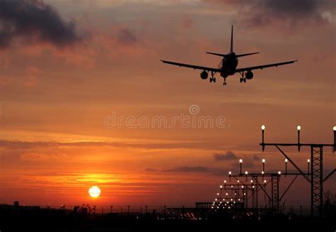 Plane landing in a sunset stock image. Image of commercial - 28132353