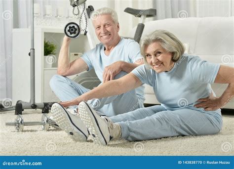 Portrait of Happy Sporty Senior Couple Exercising Stock Photo - Image of indoors, elder: 143838770