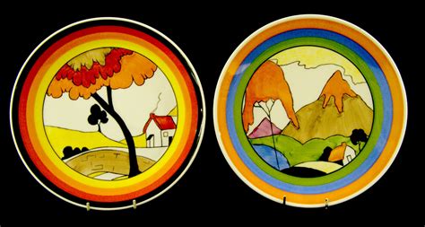 Lot 1225 - Two `Marjory Higginson` wall plates painted with Clarice Cliff designs (Mountain and ...