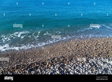 French coastline of Normandy in Etretat, France with pebbles beaches, part of the typical ...