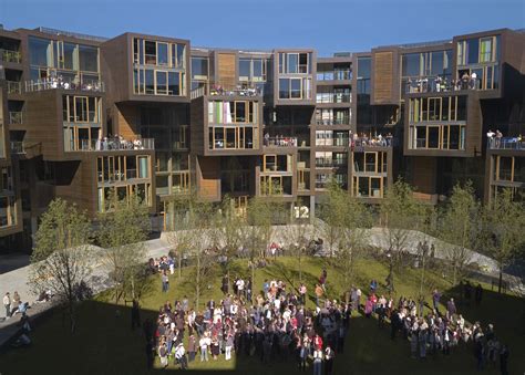 a group of people standing in front of a building with lots of balconies