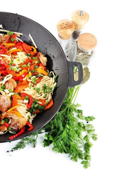 Premium Photo | Noodles with vegetables on wok isolated on white