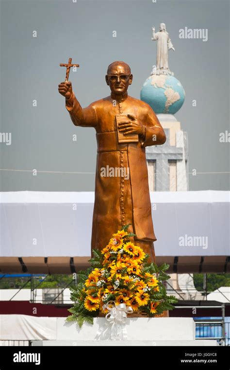 A golden statue of martyred Archbishop Oscar Romero across from the Plaza El Salvador Del mundo ...