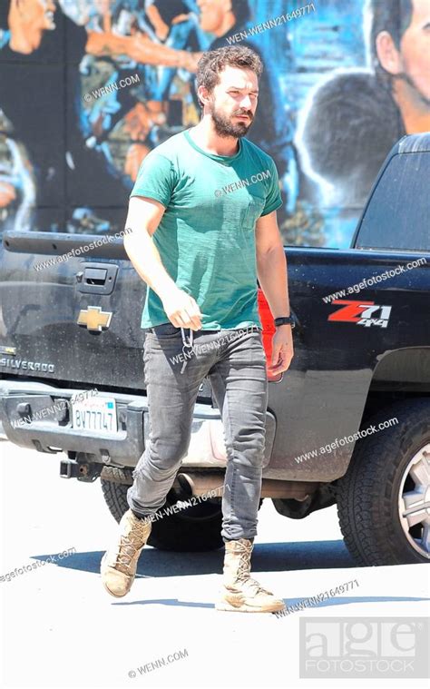 Shia LaBeouf wearing an old plain green t-shirt and black skinny jeans with scruffy boots goes ...