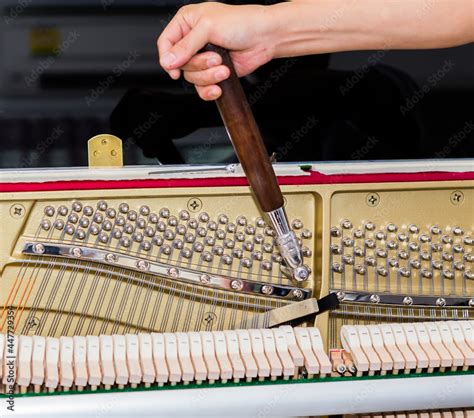 Piano tuner tuning upright piano Stock Photo | Adobe Stock