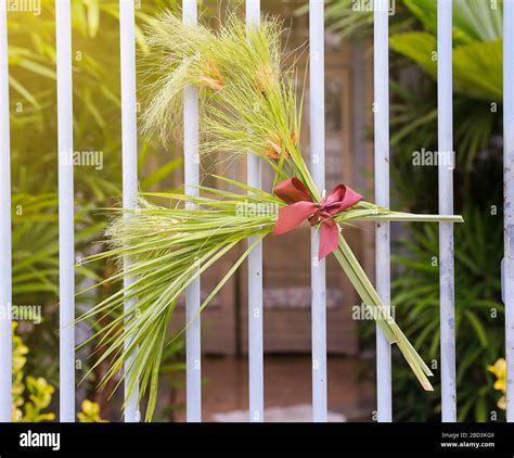 arrangement with branches and fabric lace on gate during Catholic Palm ...