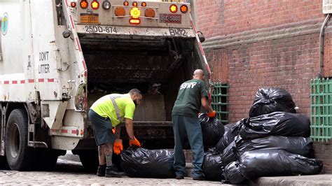 Two Men Loading Trash Into Garbage Truck In Stock Footage SBV-310358600 - Storyblocks