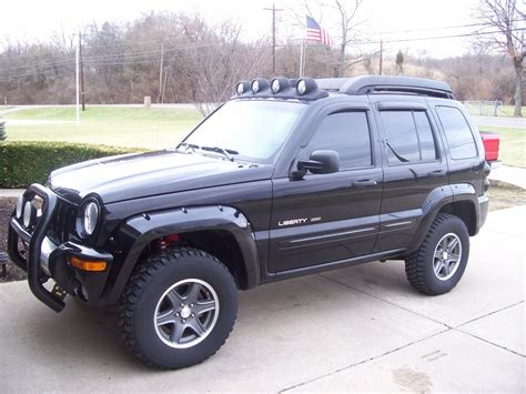 a black jeep is parked on the sidewalk