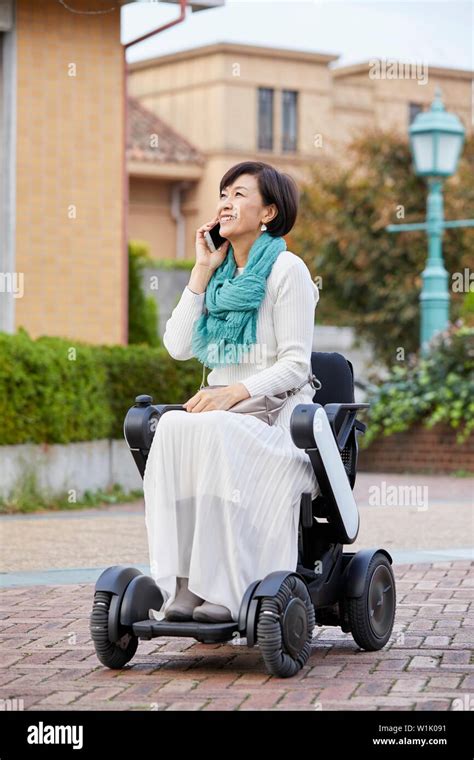 Japanese senior woman on electric wheelchair Stock Photo - Alamy