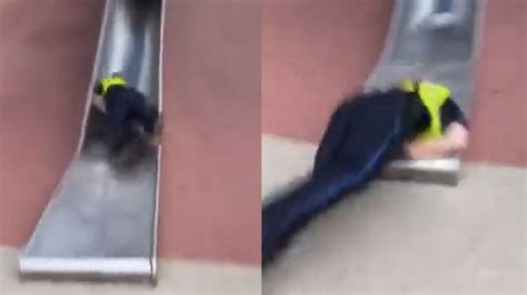 Video of Boston police officer getting hurt going down a kids slide ...