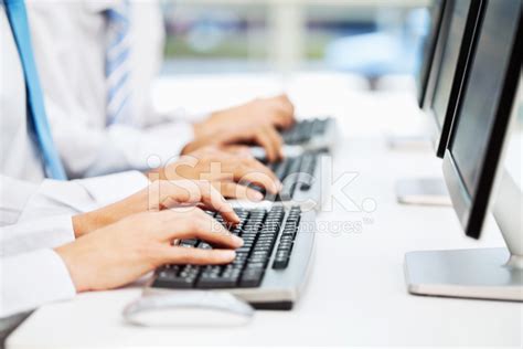 Businesspeople Working On Desktop Computer Stock Photo | Royalty-Free | FreeImages