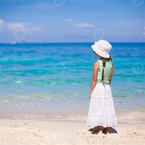 Back view of adorable little girl on tropical beach 17755273 Stock Photo at Vecteezy