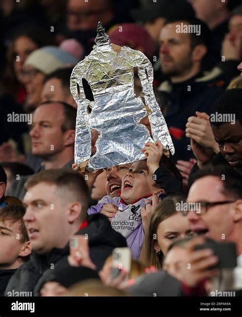 A Liverpool fan with a foil FA cup trophy replica during the Emirates ...