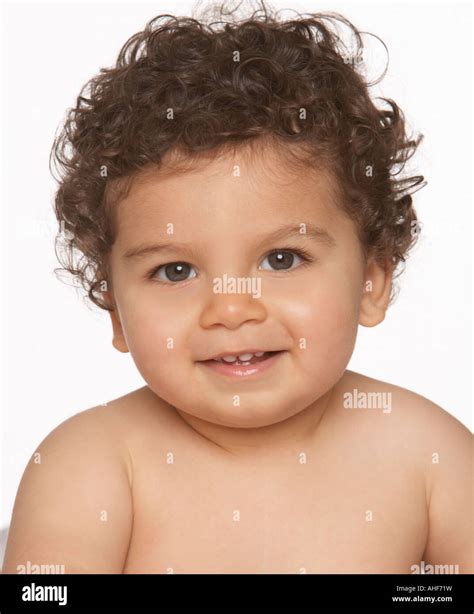 dark curly haired white baby boy sitting up and smiling against a Stock Photo, Royalty Free ...