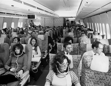 Economy class cabin of a Qantas 747B in the early 1970s enjoy their ...