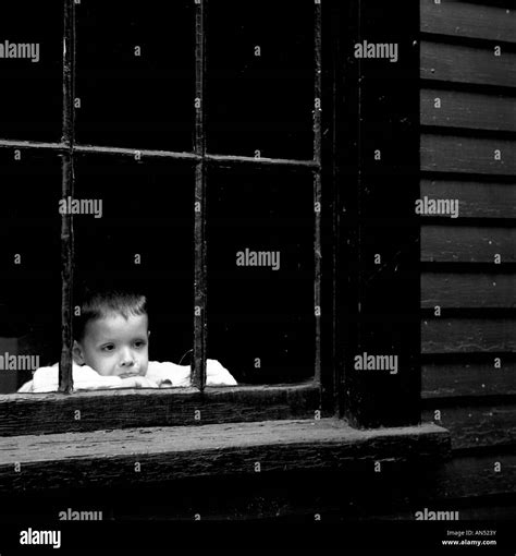 sad boy in window Stock Photo - Alamy