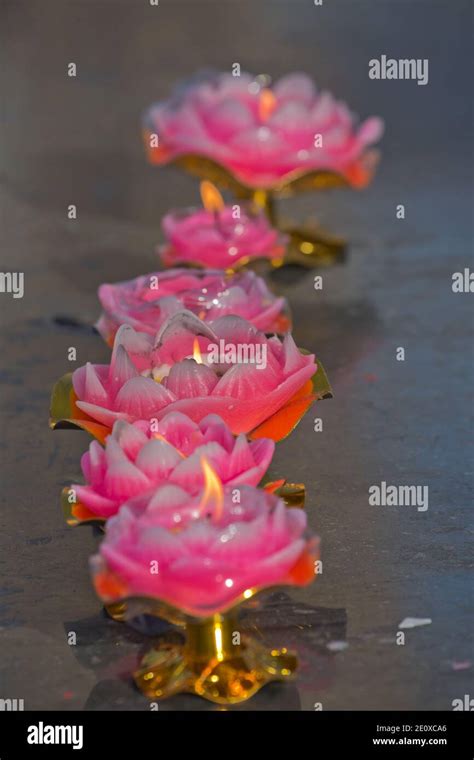 Tibetan Buddhist candles alight Stock Photo - Alamy