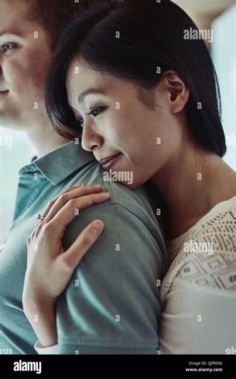 This is my shoulder to lean on. an attractive young woman embracing her husband from behind ...