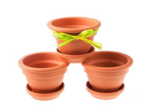 Three small clay flower pots with saucers Photograph by Arletta Cwalina - Fine Art America
