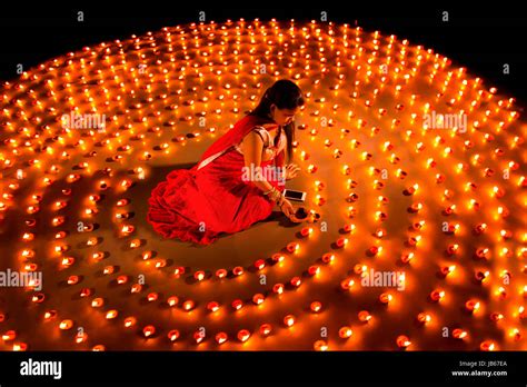 Indian woman lighting oil lamp hi-res stock photography and images - Alamy