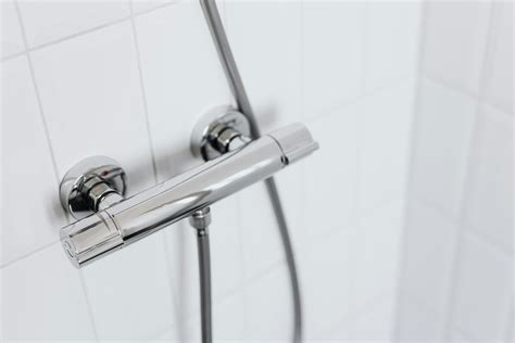 Stainless Steel Shower Head on White Ceramic Tiles · Free Stock Photo