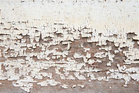 White wood wall with peeling paint background and a closeup texture ...