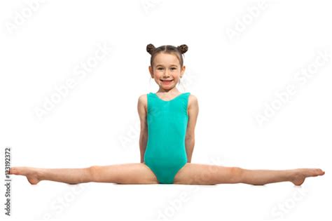 Little girl gymnast sitting in the splits. Isolated on white - Buy this stock photo and explore ...