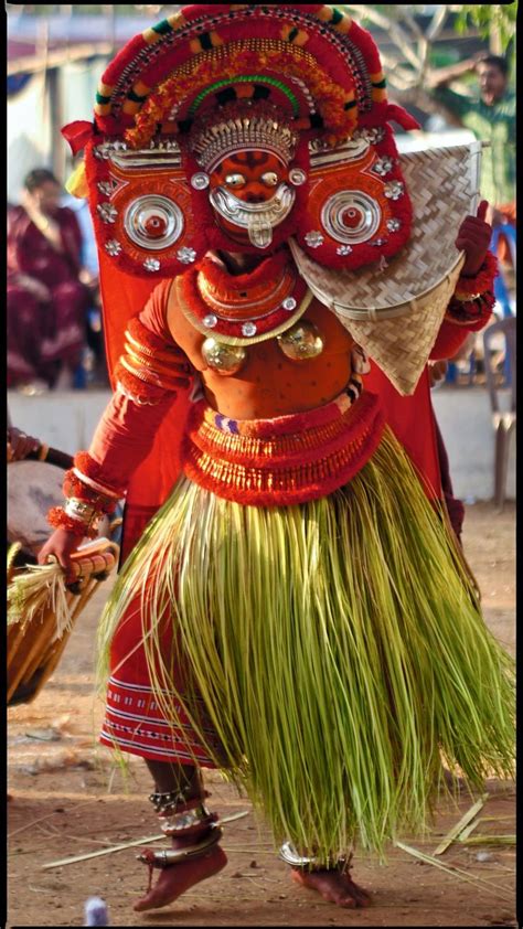 Theyyam Artist With Traditional Makeup On His Face Dressed For The ...