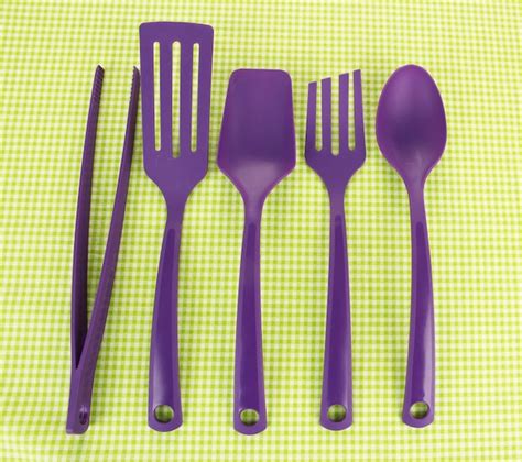 Premium Photo | Plastic kitchen utensils on fabric background
