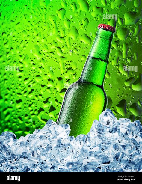 Green beer bottle in ice on green background with drops Stock Photo - Alamy