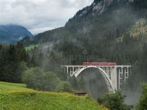 Train in the Swiss Alps stock photo. Image of bridge - 149746678