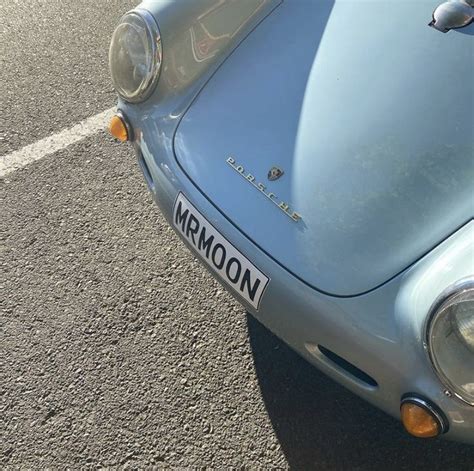 the front end of an old blue sports car