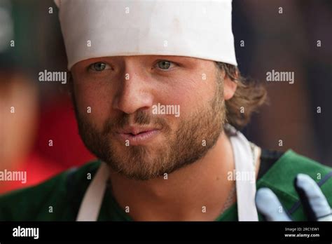 First baseman Tyler Miller (51) of the Greenville Drive wears the "Boys are Cookin'" chef's hat ...