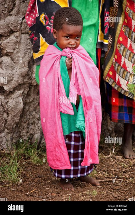 Masai Child, wearing traditional clothing, in a village in the Masai Mara, Kenya, Africa Stock ...