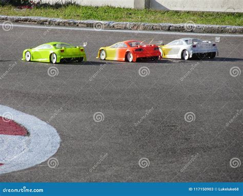 Small Radio Controlled Model Cars on the Track . Miniature Remote ...