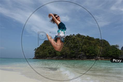 Image of Woman Jumping in Joy In a Beach-YU423477-Picxy