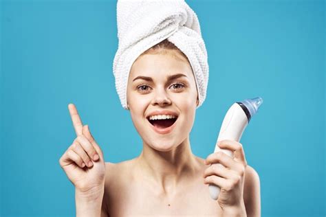 Premium Photo | Cheerful woman with a towel on her head massagers in hands dermatology clean ...