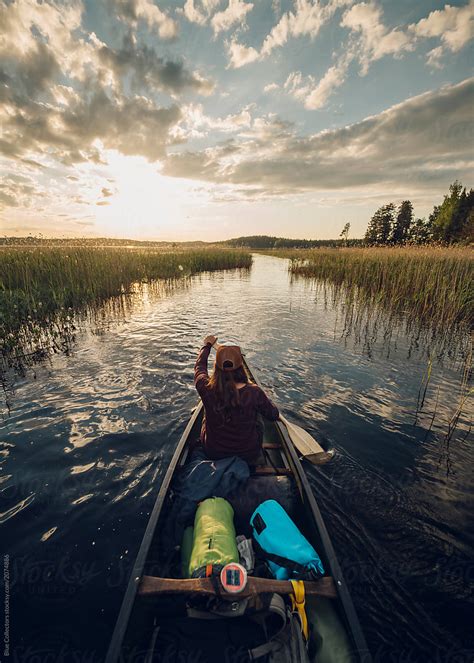 "Back View Of A Woman Canoeing In A Vibrant Lake At The Sunset" by ...