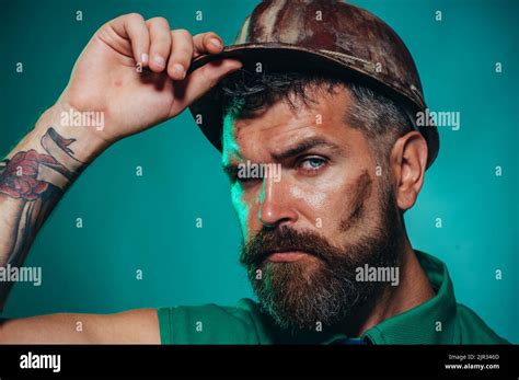 Male builder in hard hat. Construction worker in safety helmet. Portrait of handsome architect ...