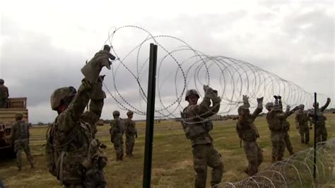 Barbed wire fences set up along U.S.-Mexico border as migrant caravan continues journey - ABC13 ...